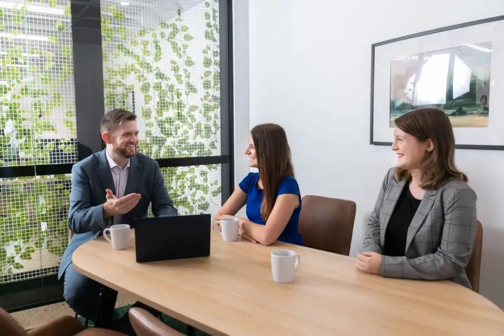 employees discussing something funny during coffee break